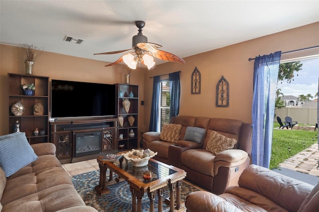 tiled living room featuring ceiling fan