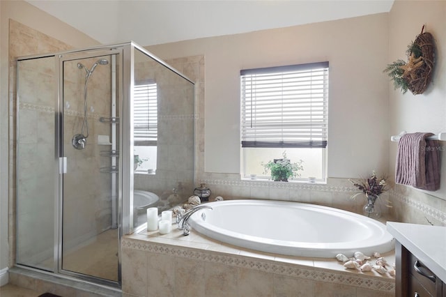 bathroom with vanity and shower with separate bathtub