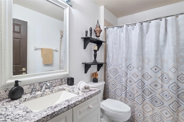 bathroom with walk in shower, vanity, and toilet