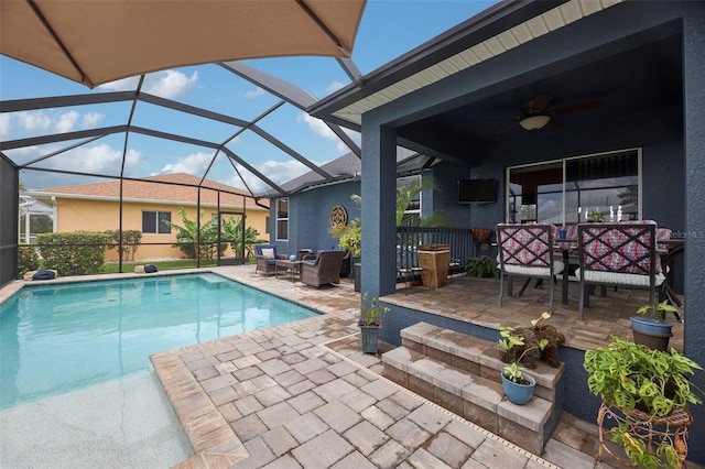 view of pool with a lanai, an outdoor hangout area, ceiling fan, and a patio area