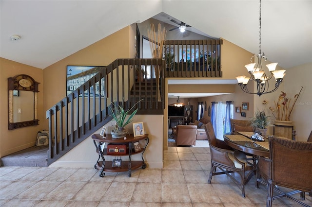 interior space with ceiling fan with notable chandelier and vaulted ceiling