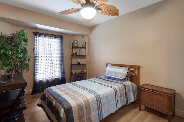 bedroom featuring light hardwood / wood-style floors and ceiling fan