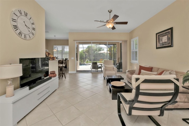 tiled living room with ceiling fan