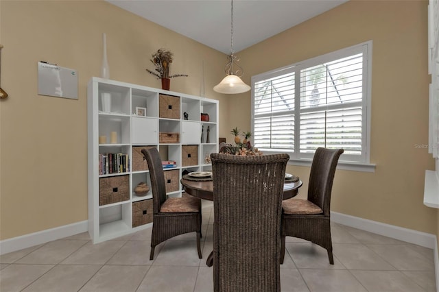 dining space with light tile patterned flooring and baseboards