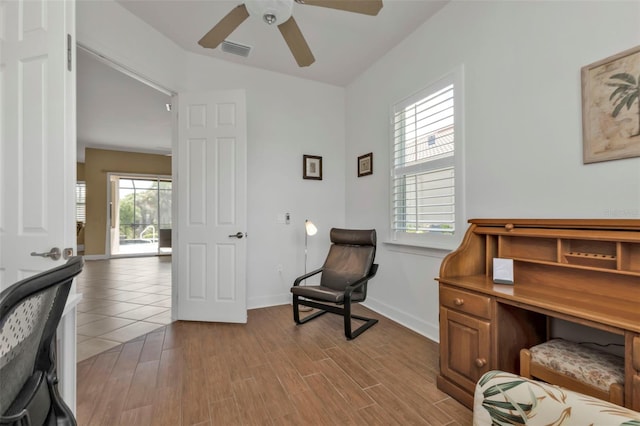 home office featuring ceiling fan and light hardwood / wood-style flooring