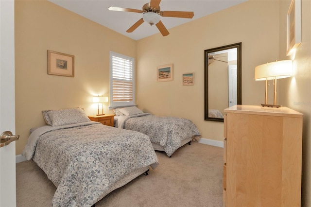 bedroom with ceiling fan and light colored carpet