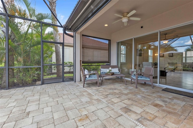 view of patio / terrace with a lanai, ceiling fan, and an outdoor hangout area