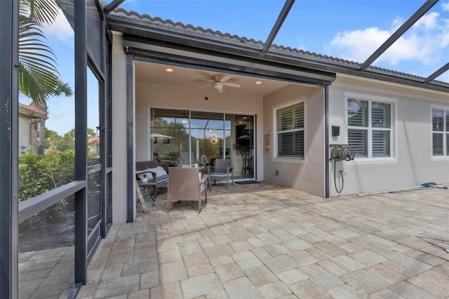 view of patio with a lanai and ceiling fan