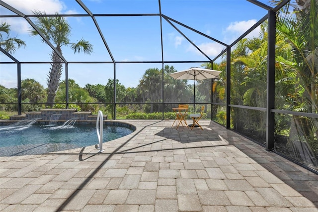 pool with glass enclosure and a patio area