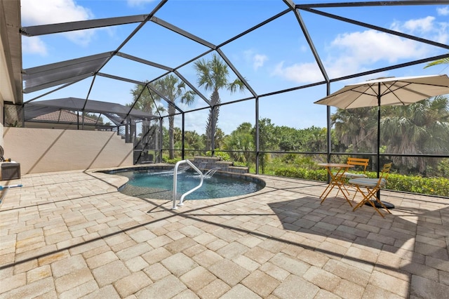 view of swimming pool with glass enclosure, a hot tub, pool water feature, and a patio area