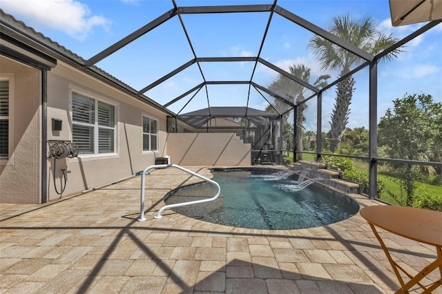 view of swimming pool with a patio, a lanai, and pool water feature