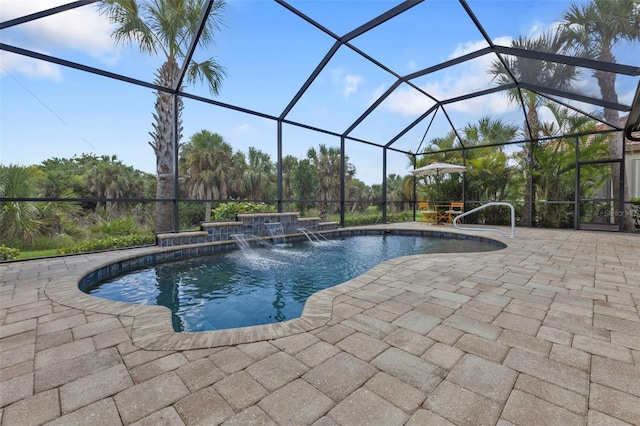 view of swimming pool with pool water feature, a hot tub, glass enclosure, and a patio area