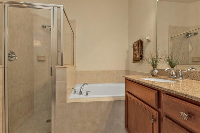 bathroom with a shower stall, vanity, and a bath