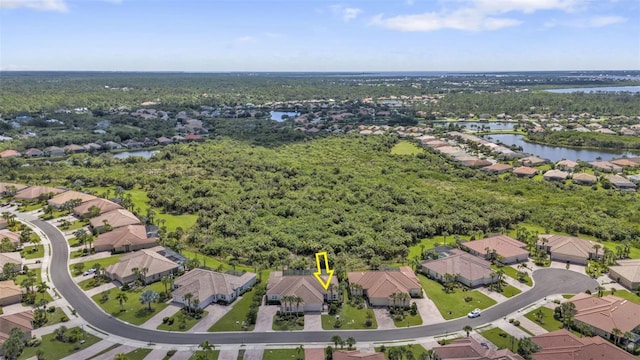 birds eye view of property with a water view and a residential view