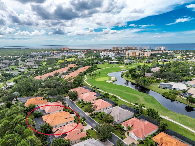 bird's eye view featuring golf course view and a water view