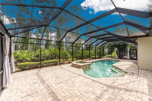 view of swimming pool featuring a lanai, a pool with connected hot tub, and a patio