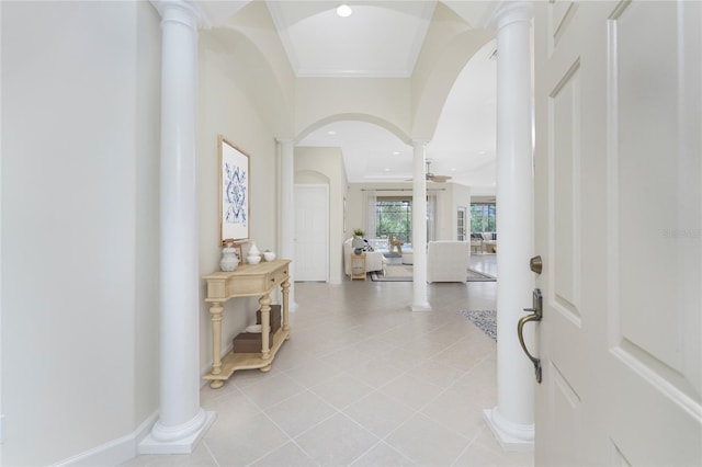 entryway featuring light tile patterned flooring, ornamental molding, and decorative columns