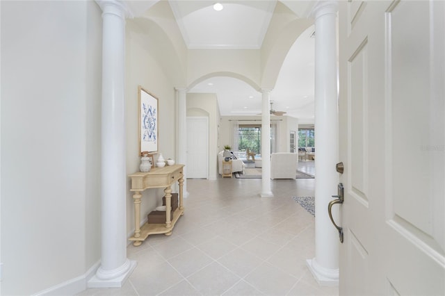 entrance foyer featuring arched walkways, light tile patterned flooring, recessed lighting, ornate columns, and crown molding