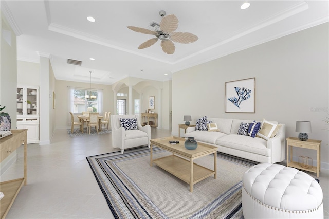 living area with recessed lighting, ornate columns, a tray ceiling, visible vents, and ceiling fan