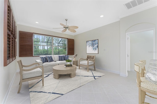 tiled living room with ceiling fan and ornamental molding