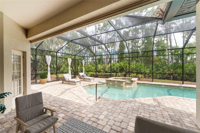 view of swimming pool featuring a lanai, a patio area, and an in ground hot tub