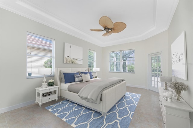 tiled bedroom featuring ceiling fan, ornamental molding, access to outside, and a tray ceiling