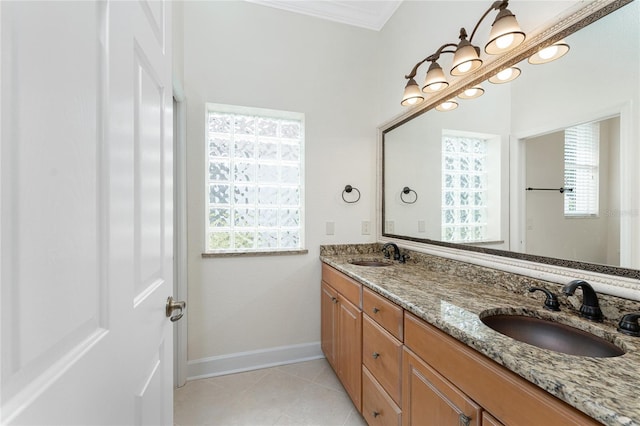 full bath with double vanity, tile patterned flooring, baseboards, and a sink