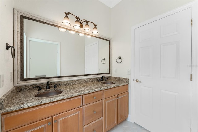 full bathroom with tile patterned flooring, a sink, and double vanity
