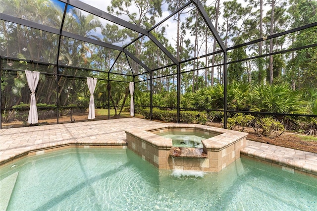 view of swimming pool featuring a pool with connected hot tub, a lanai, and a patio