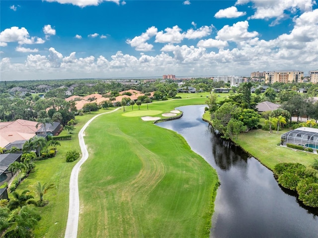 birds eye view of property featuring view of golf course and a water view