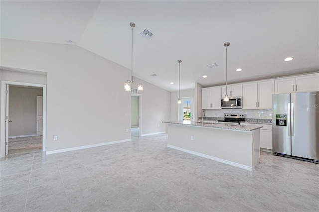 kitchen featuring decorative light fixtures, lofted ceiling, stainless steel appliances, and white cabinets