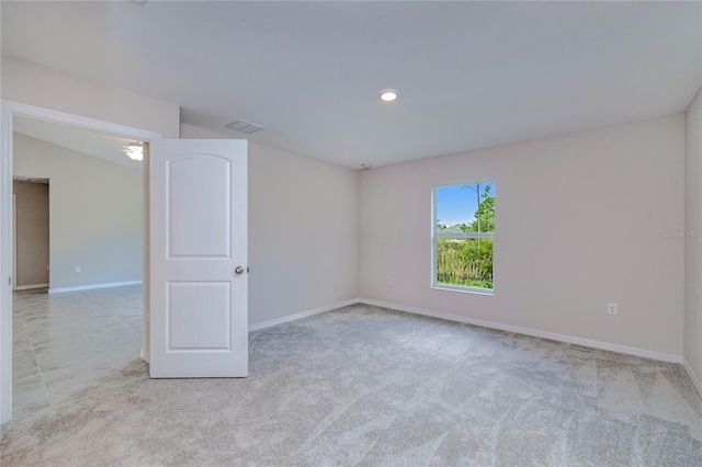 empty room featuring lofted ceiling and light colored carpet