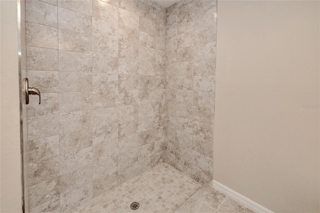 bathroom with a tile shower