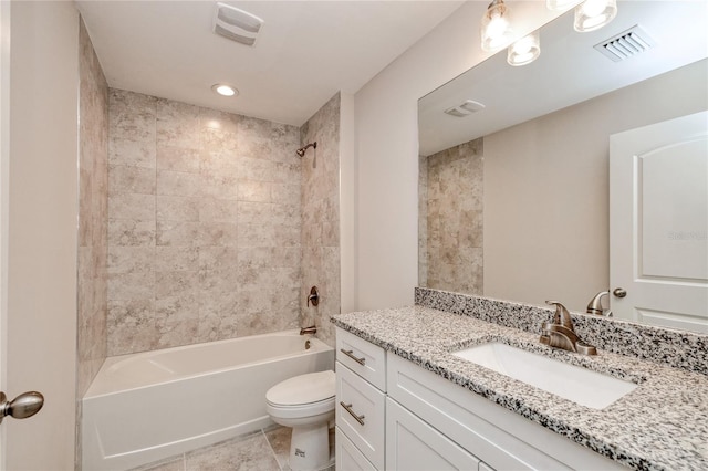 full bathroom with vanity, tile patterned flooring, tiled shower / bath, and toilet