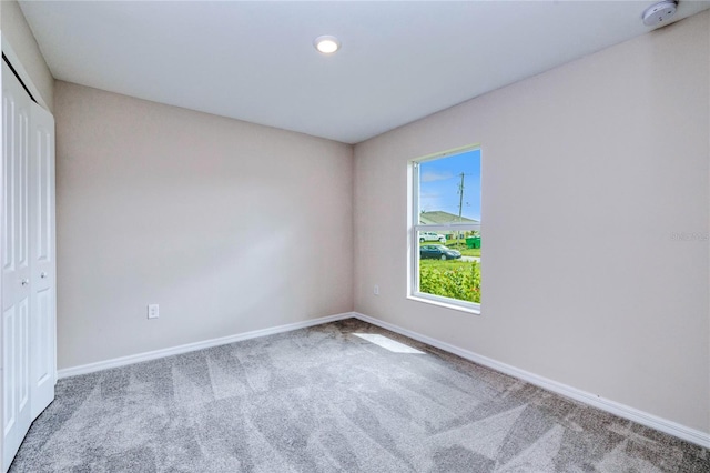 unfurnished bedroom featuring carpet floors and a closet