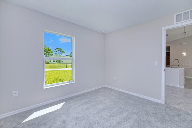 carpeted spare room with sink