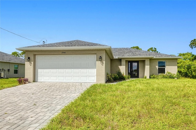 ranch-style home featuring a front lawn and a garage