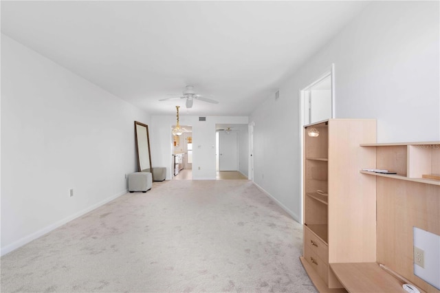 unfurnished living room featuring ceiling fan and light carpet