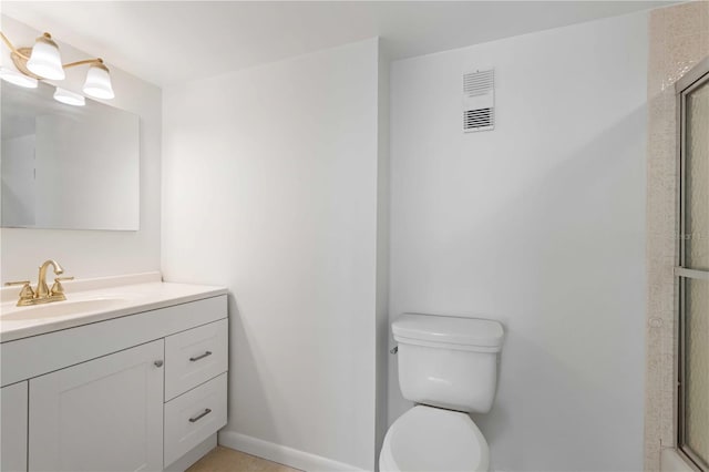 bathroom with walk in shower, vanity, and toilet