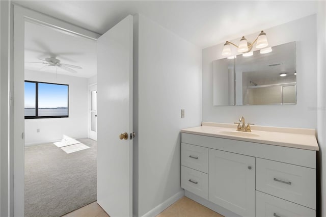 bathroom featuring walk in shower, vanity, and ceiling fan