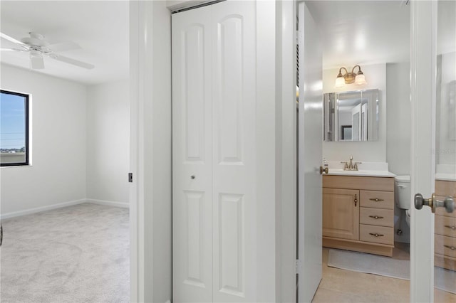 bathroom with ceiling fan and vanity