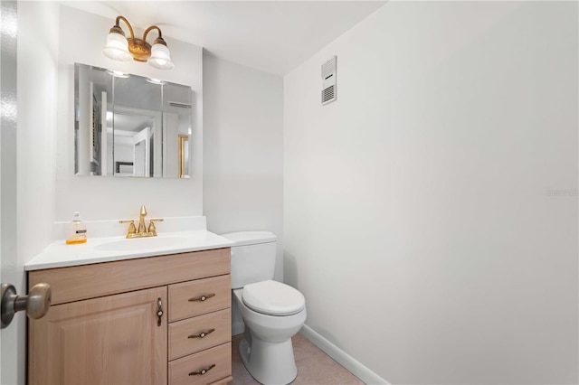 bathroom featuring tile patterned floors, vanity, and toilet