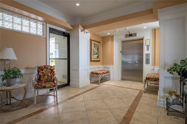 interior space featuring light tile patterned flooring, ornamental molding, and elevator