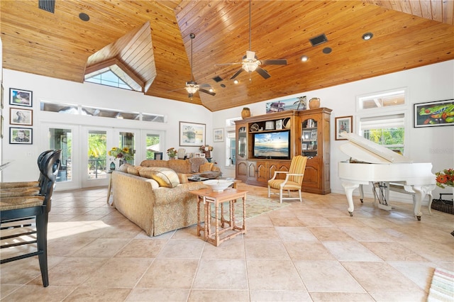 tiled living room featuring a healthy amount of sunlight, a high ceiling, ceiling fan, and french doors