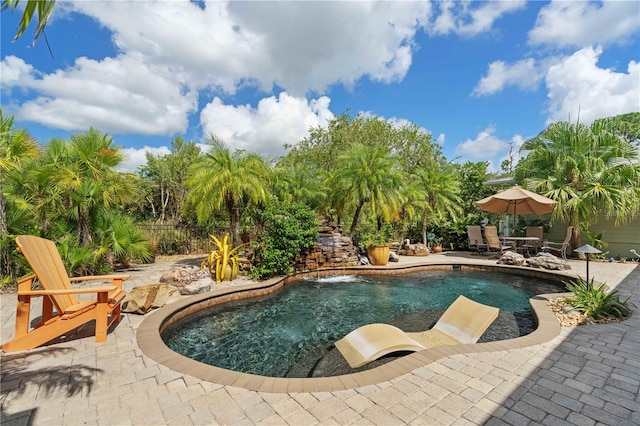 view of pool with pool water feature and a patio area