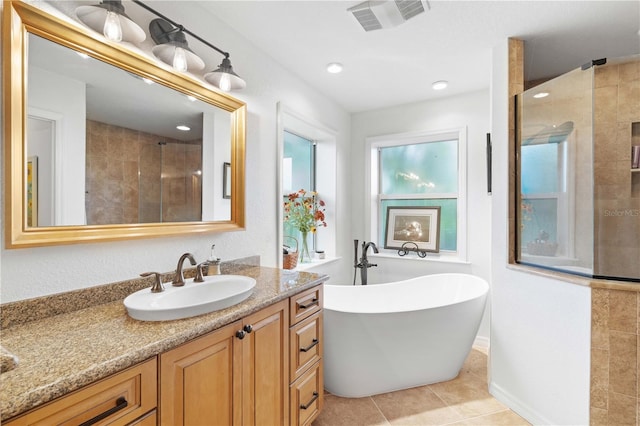 bathroom with independent shower and bath, tile patterned flooring, and vanity