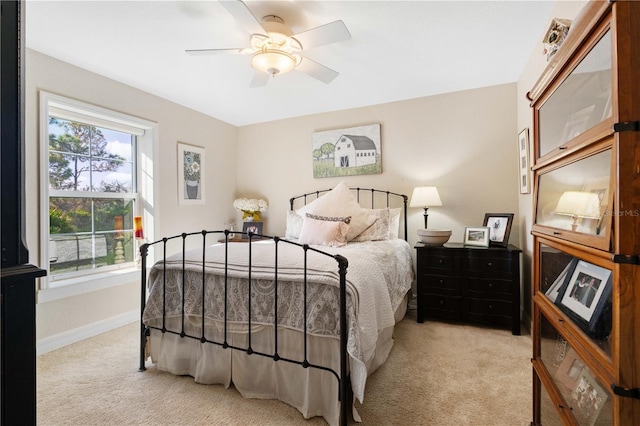 bedroom featuring ceiling fan and light carpet