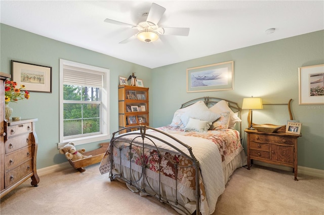 bedroom with ceiling fan and light carpet