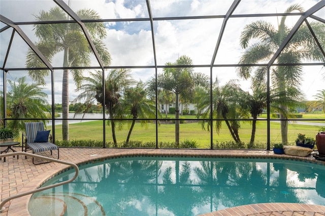 view of pool with a patio and glass enclosure