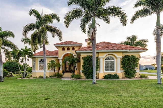 mediterranean / spanish-style home with a front yard